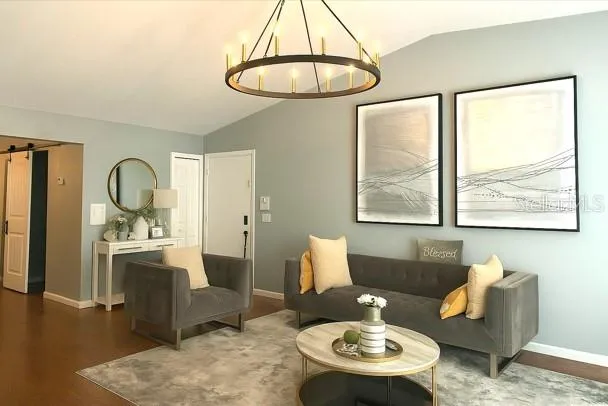 a living room with furniture a table and a large window