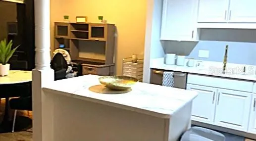 a kitchen with a sink a stove and cabinets