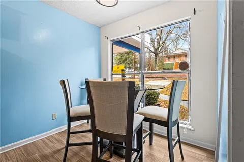 a dining room with furniture and window