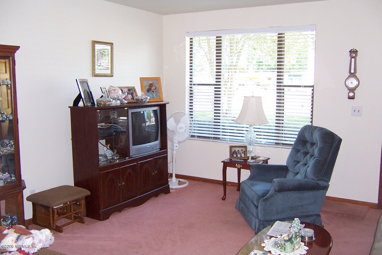 4637 Spring Park Road Jacksonville, FL 32207 - Photo 2 of 10 a living room with furniture and a window