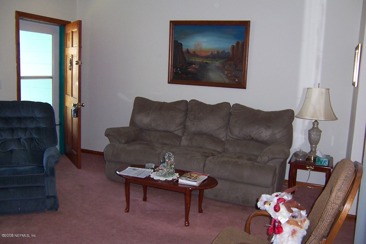 4637 Spring Park Road Jacksonville, FL 32207 - Photo 3 of 10 a living room with furniture and a couch