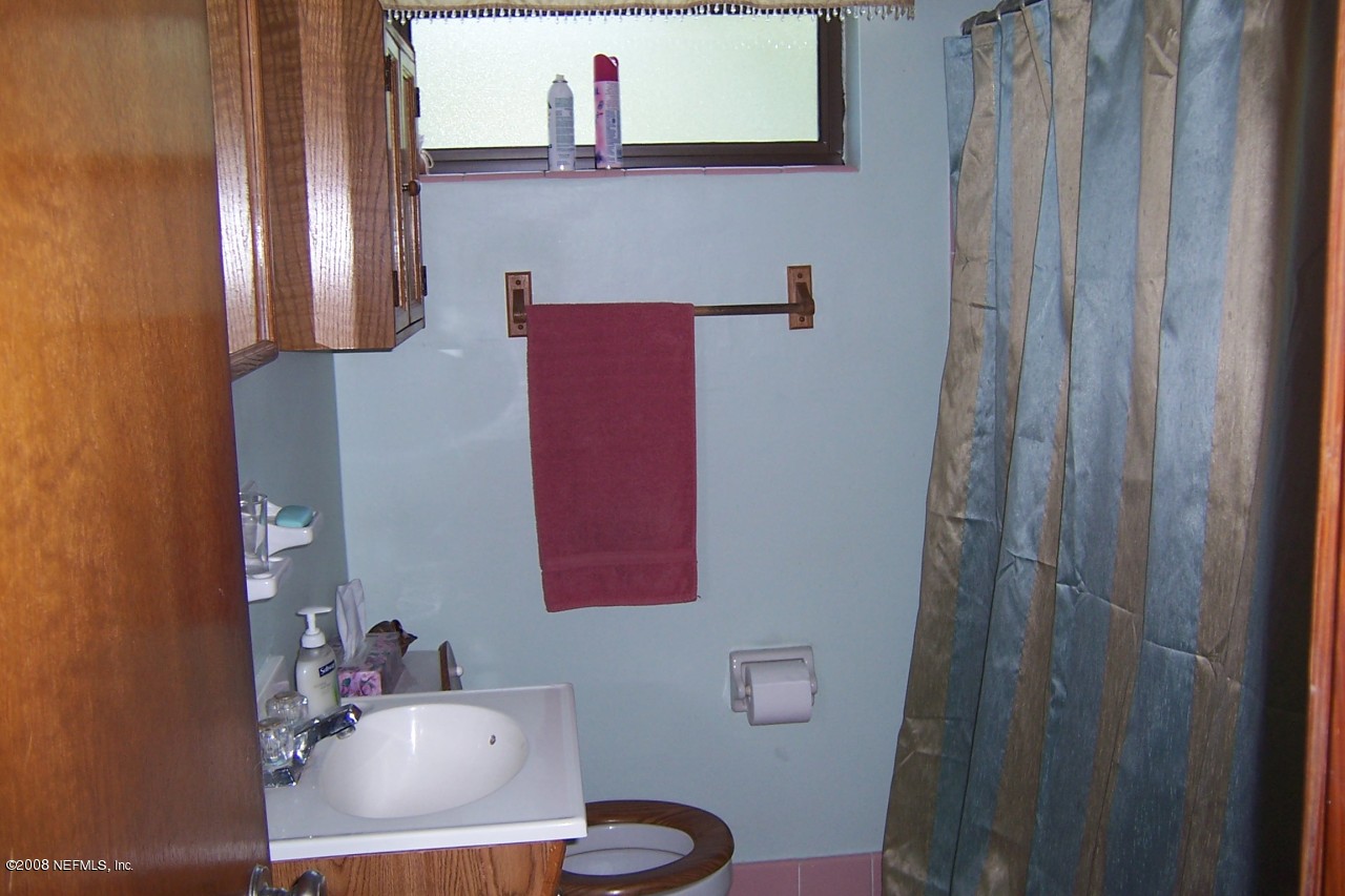 4637 Spring Park Road Jacksonville, FL 32207 - Photo 4 of 10 a bathroom with a sink toilet and mirror