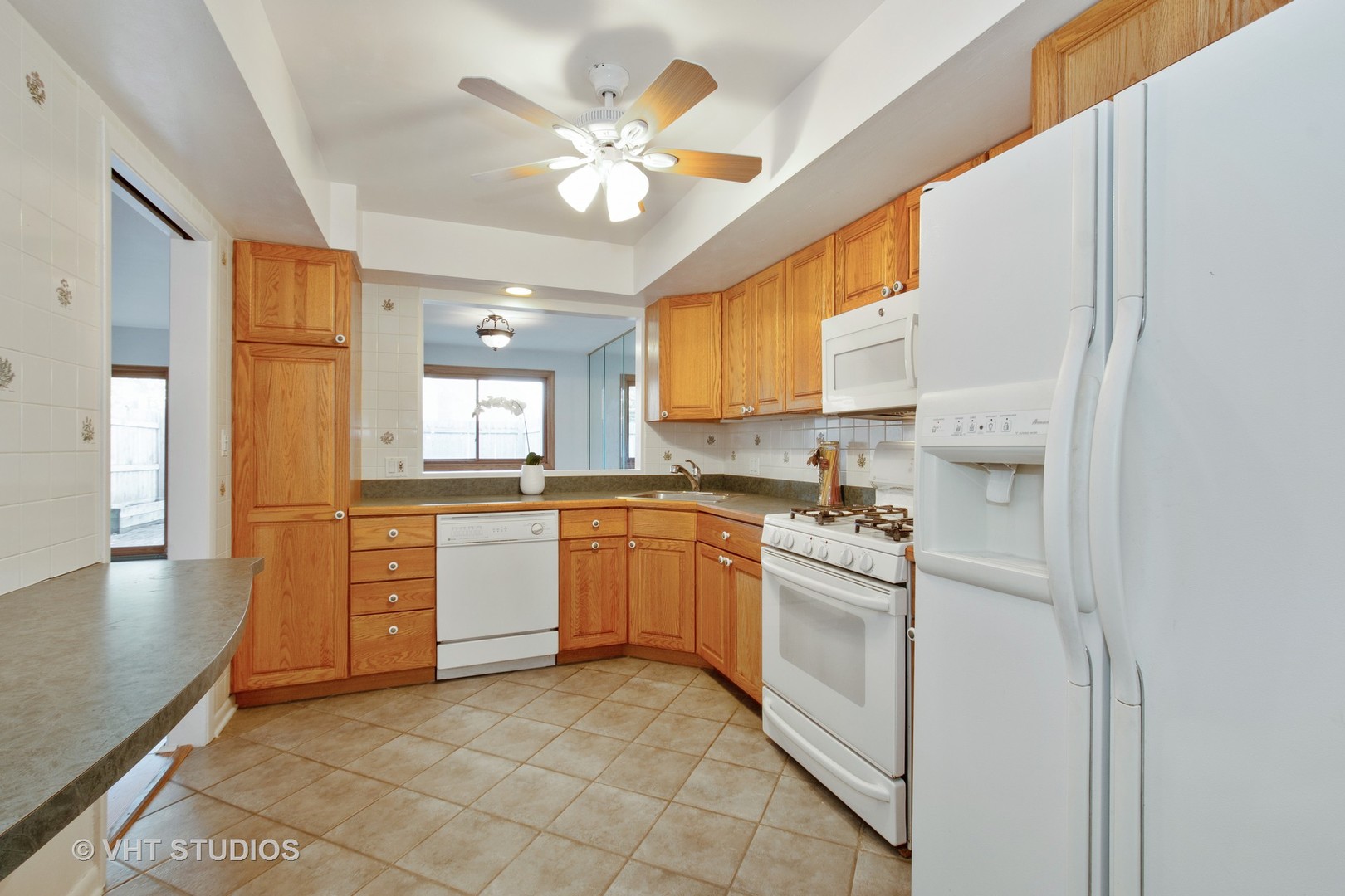731 Hibbard Road Wilmette, IL 60091 - Photo 8 of 18 a kitchen with a stove a sink and a refrigerator
