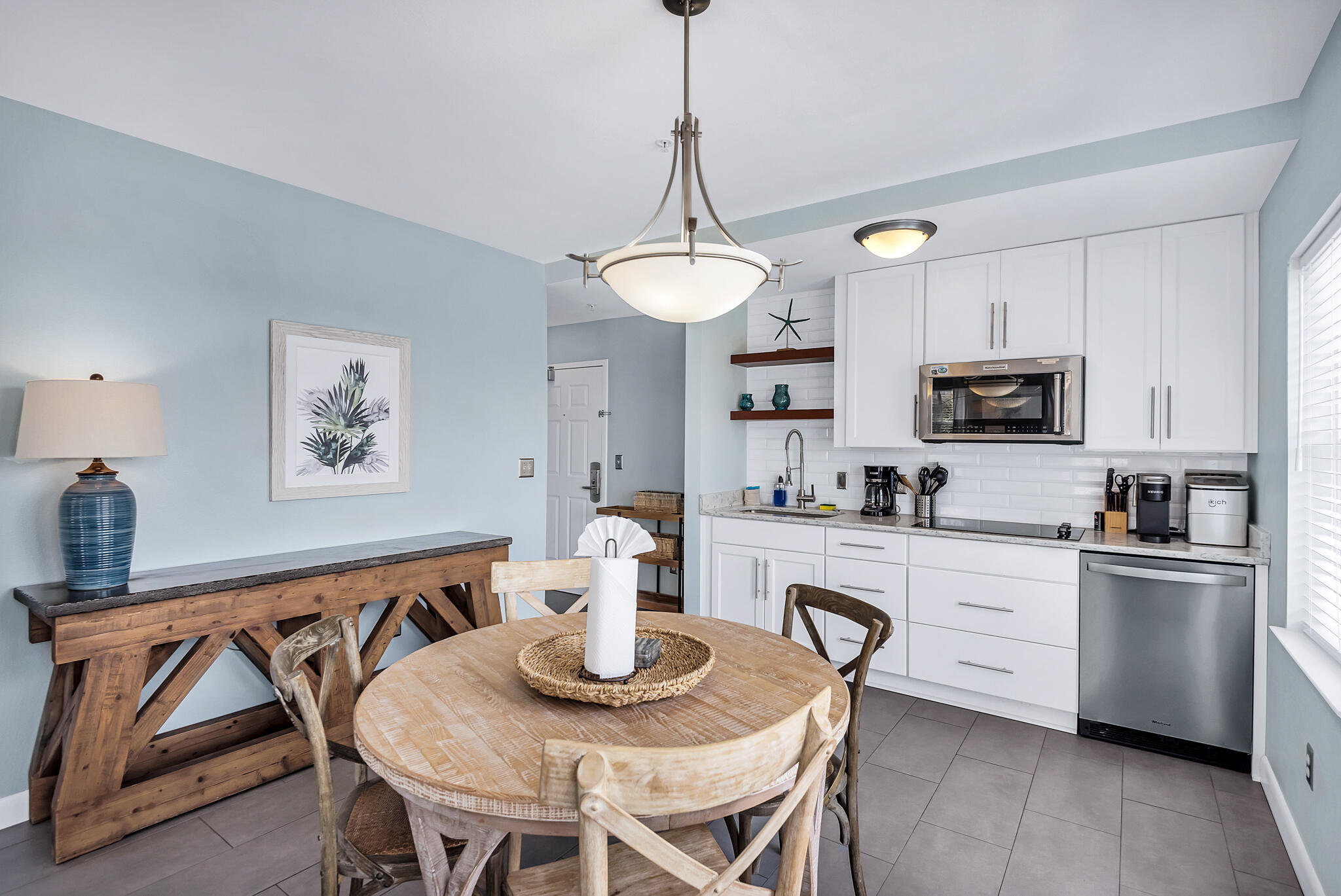 45 Town Center Loop, Unit 314 Santa Rosa Beach, FL 32459 - Photo 3 of 38 a kitchen with stainless steel appliances granite countertop a dining table chairs and a refrigerator