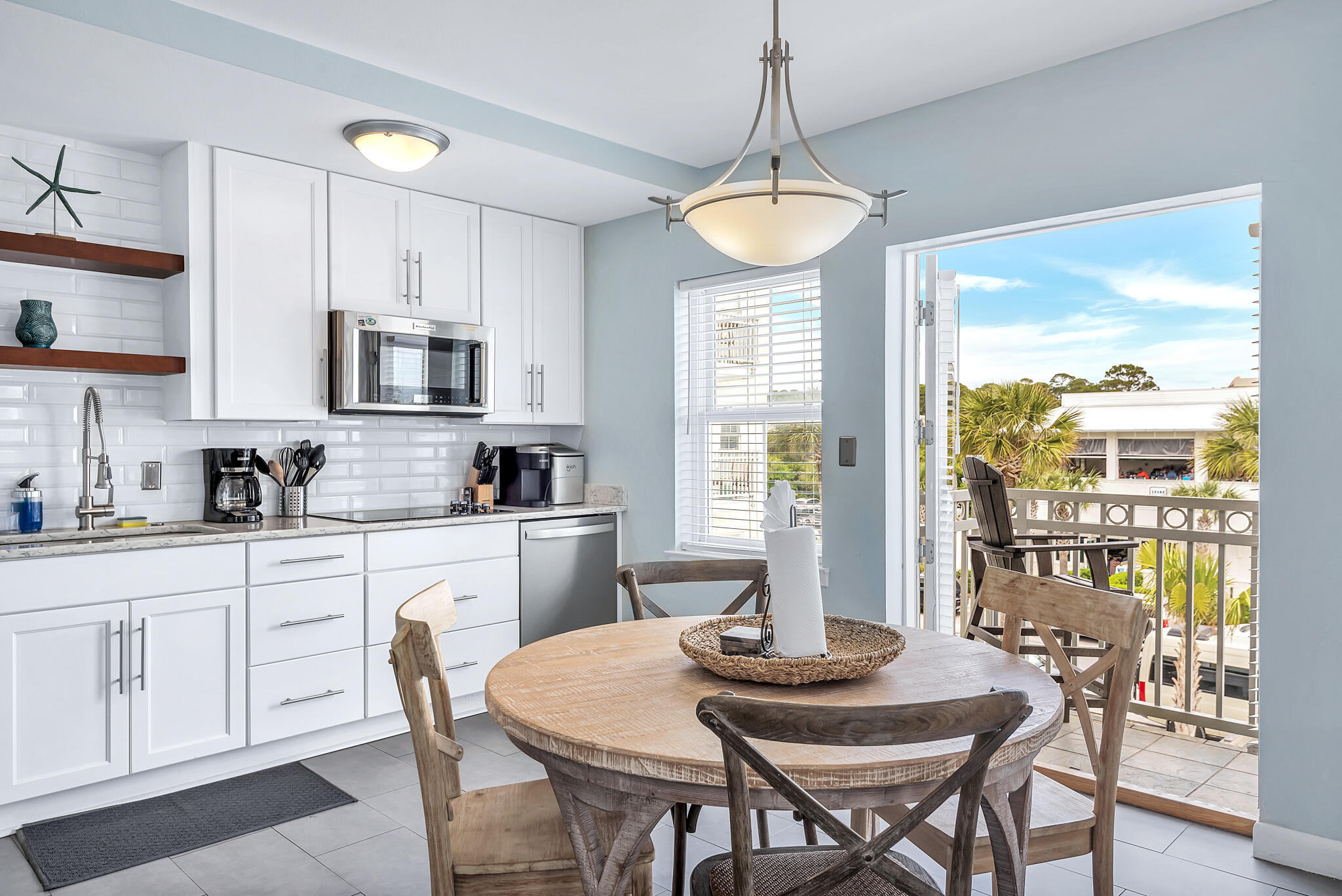 45 Town Center Loop, Unit 314 Santa Rosa Beach, FL 32459 - Photo 4 of 38 a kitchen with stainless steel appliances granite countertop a table and chairs in it