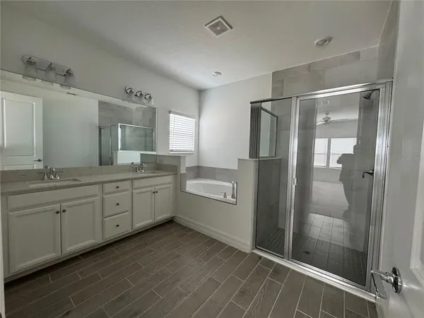 a bathroom with a granite countertop sink mirror and shower
