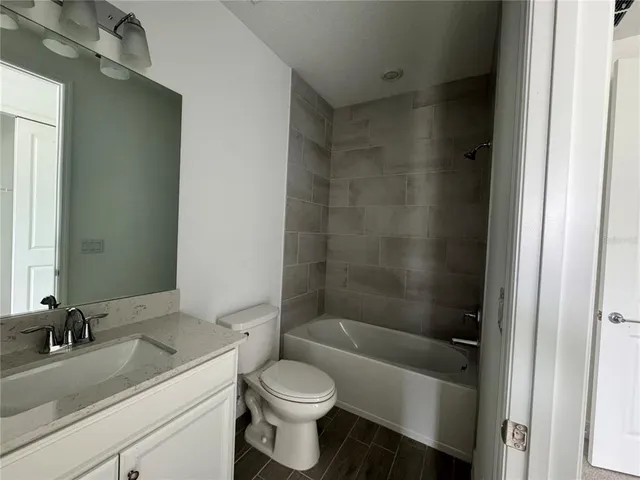 a bathroom with a sink a toilet and a bathtub