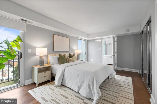 a bedroom with a bed lamp and a potted plant