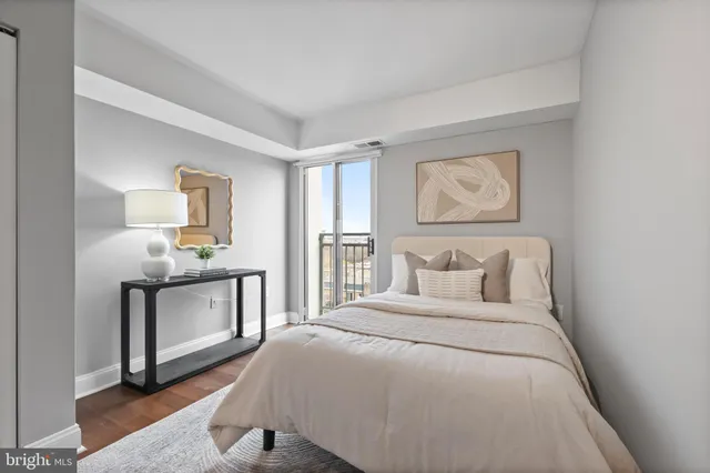 a bedroom with a large bed and a chandelier