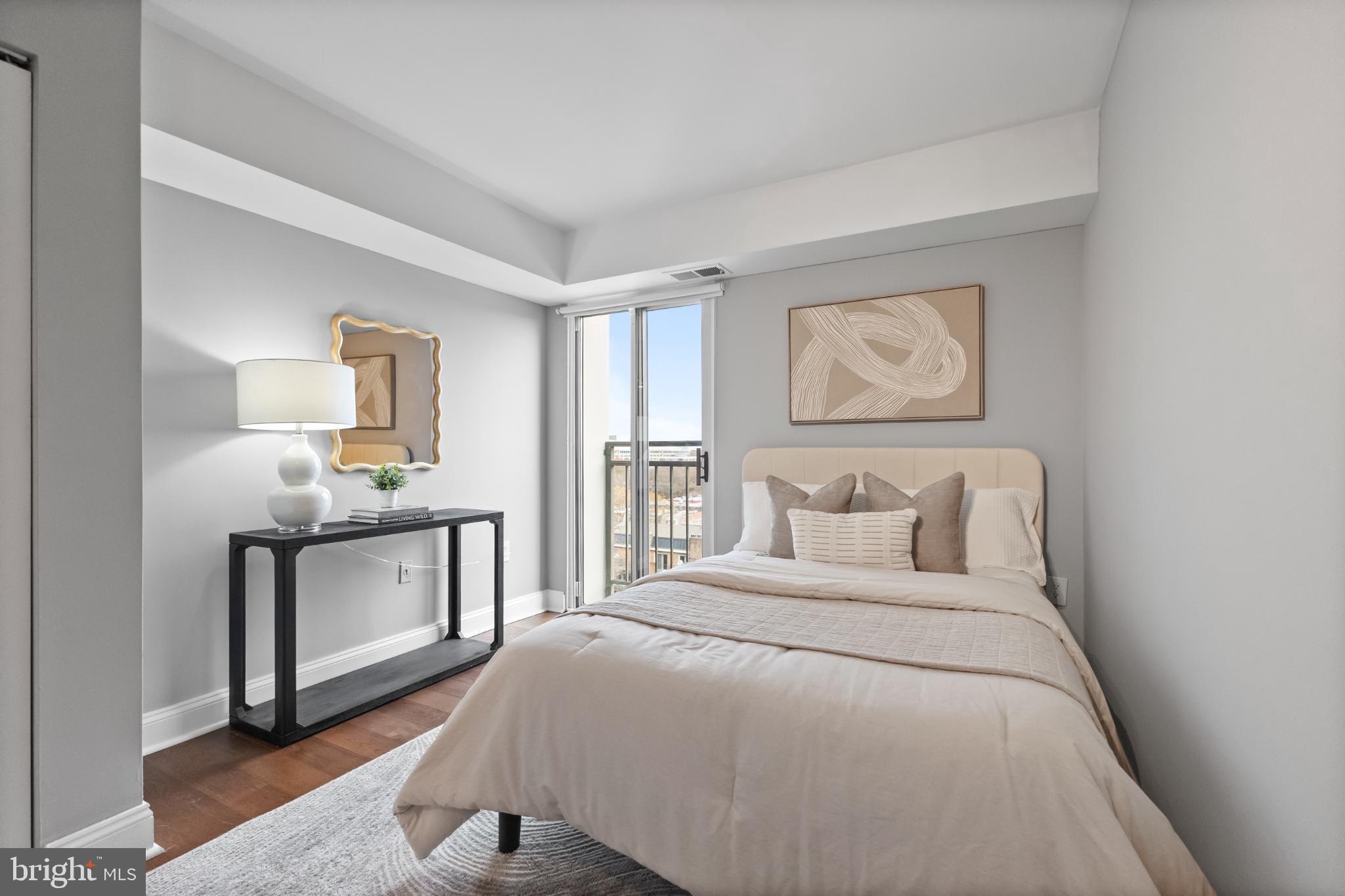 700 7th Street Southwest, Unit 813 Washington, DC 20024 - Photo 17 of 26 a bedroom with a large bed and a chandelier