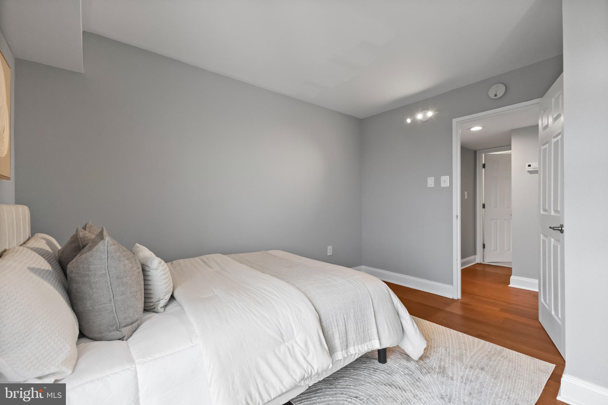 700 7th Street Southwest, Unit 813 Washington, DC 20024 - Photo 18 of 26 a bedroom with a bed and wooden floor