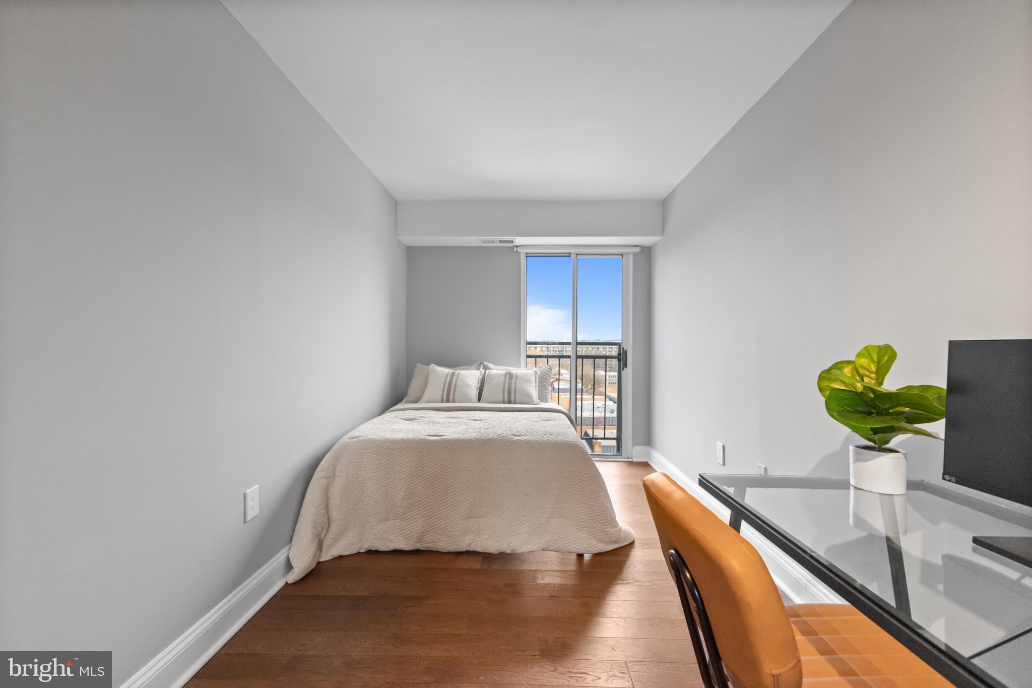 700 7th Street Southwest, Unit 813 Washington, DC 20024 - Photo 20 of 26 a bedroom with a bed and painting on the wall