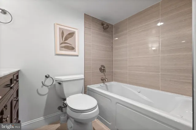 a bath room with a toilet and a bath tub