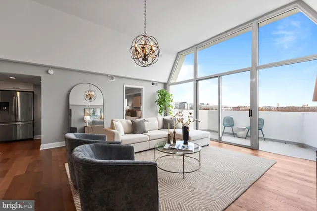 a living room with furniture large window and outdoor view
