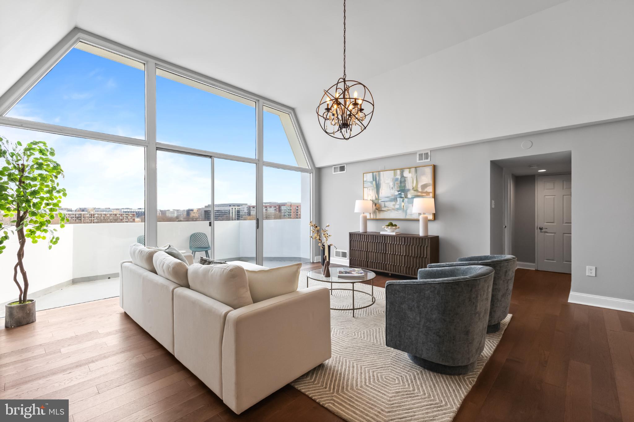 700 7th Street Southwest, Unit 813 Washington, DC 20024 - Photo 4 of 26 a living room with furniture a window and wooden floor