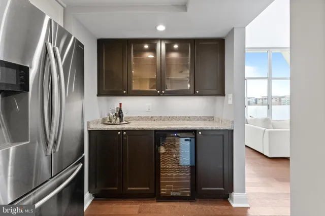 a kitchen with stainless steel appliances granite countertop a refrigerator and a sink