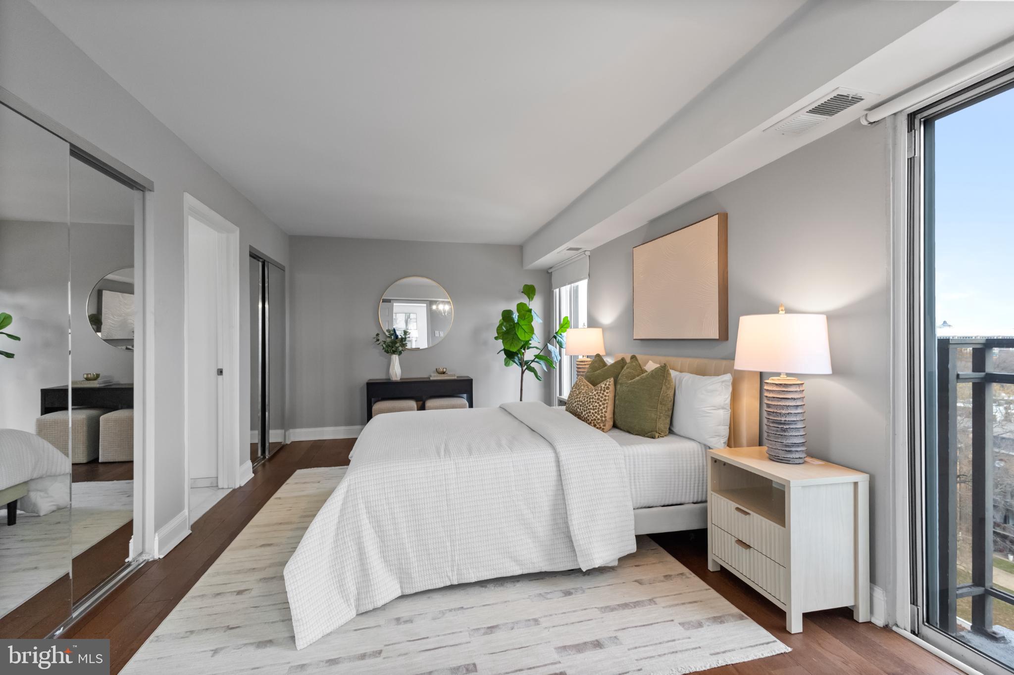 700 7th Street Southwest, Unit 813 Washington, DC 20024 - Photo 10 of 26 a bedroom with a large bed and wooden floor