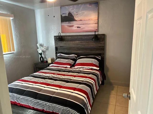 a bedroom with a bed and window