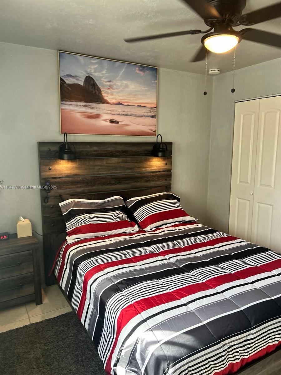 5929 Fillmore Street, Unit A Hollywood, FL 33021 - Photo 16 of 24 a bedroom with a bed and lamp