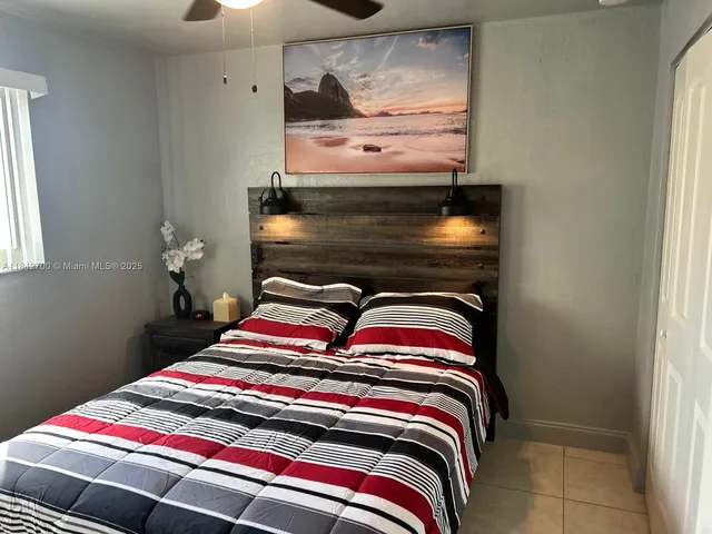 a bedroom with a bed and a painting on the wall