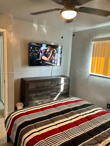 a bedroom with a bed and a wall painting