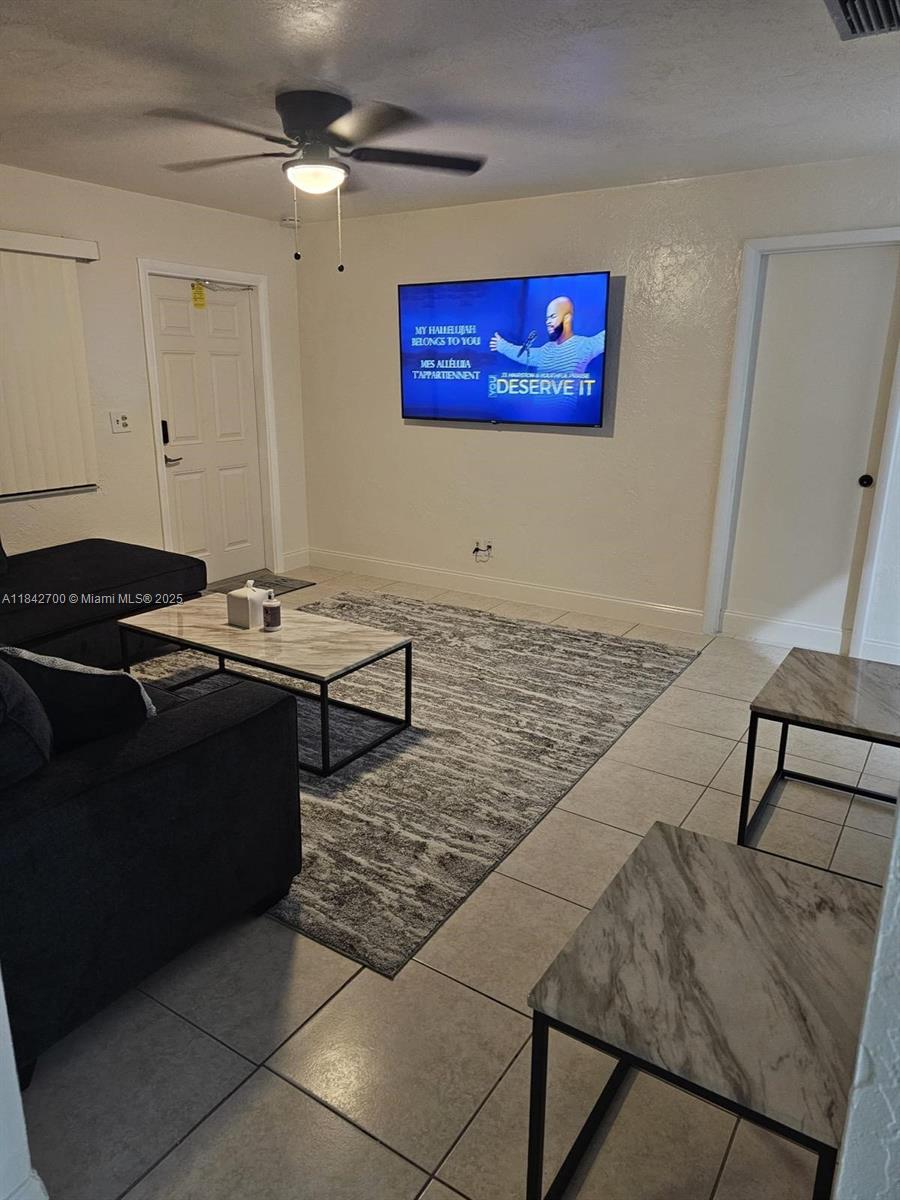5929 Fillmore Street, Unit A Hollywood, FL 33021 - Photo 2 of 24 a living room with stainless steel appliances kitchen island granite countertop furniture a rug and a window