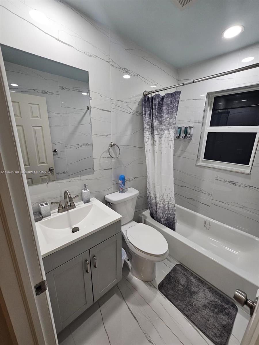 5929 Fillmore Street, Unit A Hollywood, FL 33021 - Photo 21 of 24 a bathroom with a sink toilet and shower