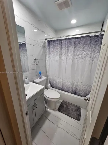 a bathroom with a toilet a sink and a shower