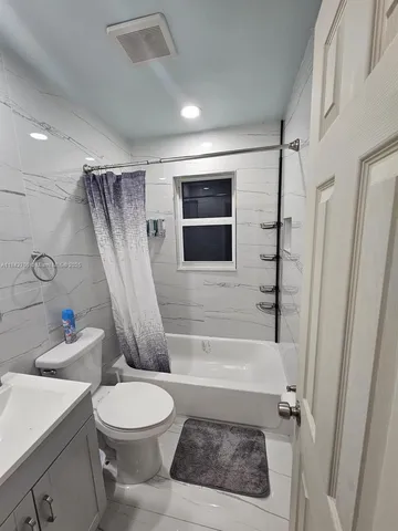 a bathroom with a toilet a sink and a bathtub