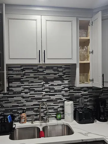 a kitchen with a sink and cabinets
