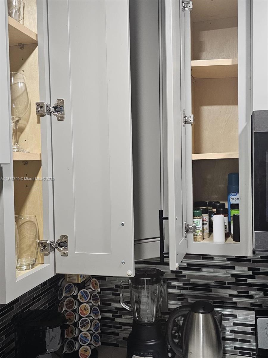 5929 Fillmore Street, Unit A Hollywood, FL 33021 - Photo 5 of 24 a bathroom with a granite countertop sink and a mirror