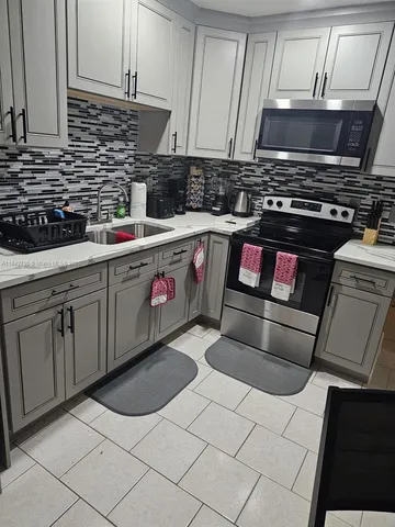 a kitchen with a stove and a sink