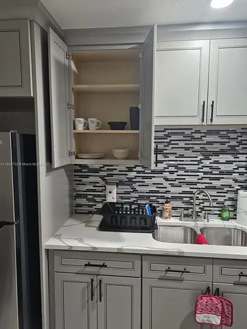 a kitchen with a sink and cabinets