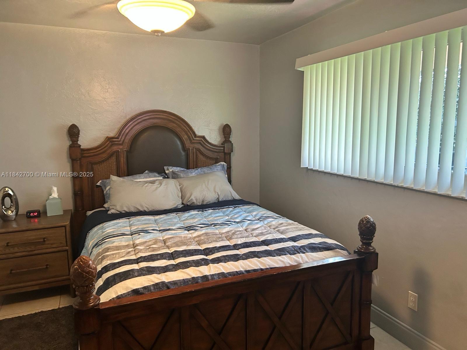 5929 Fillmore Street, Unit A Hollywood, FL 33021 - Photo 10 of 24 a bedroom with a bed and a window