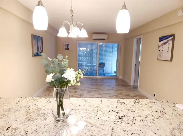 a view of a chandelier fan and entryway