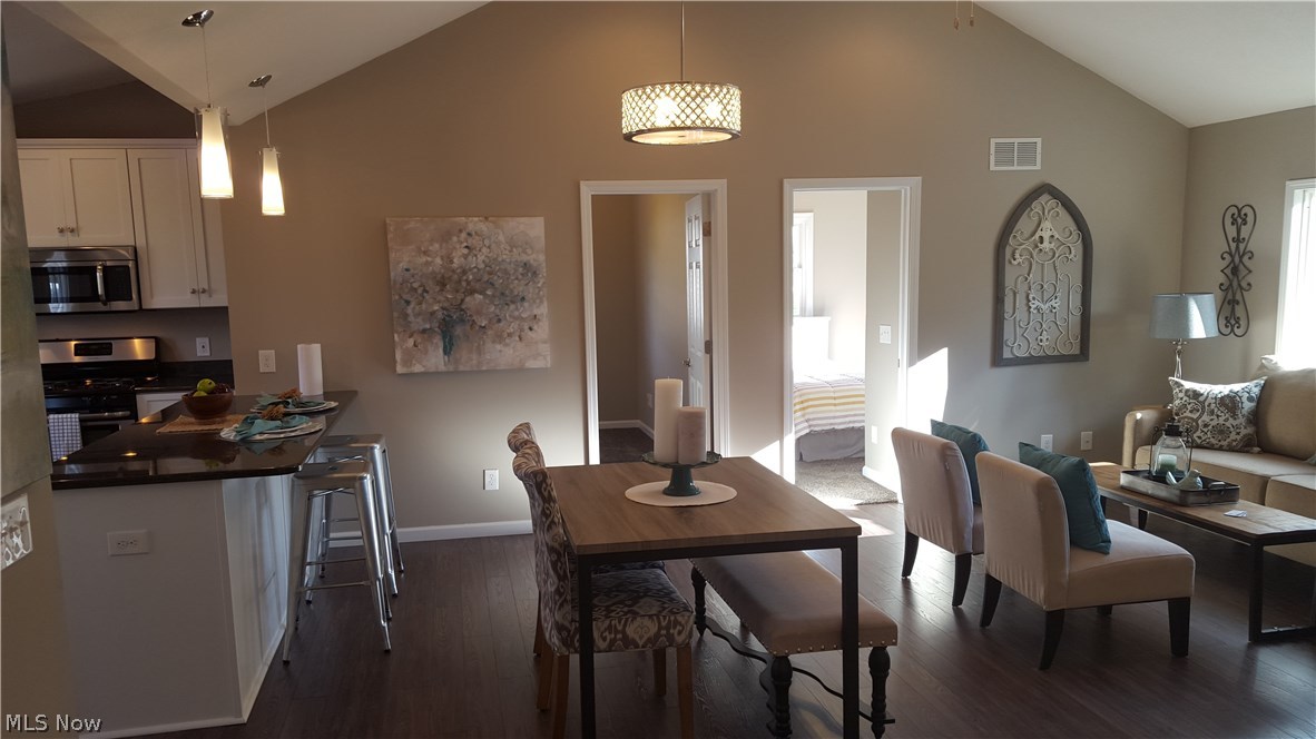 1829 Ronald Road Akron, OH 44312 - Photo 9 of 25 Dining room featuring open design and cathedral ceilings