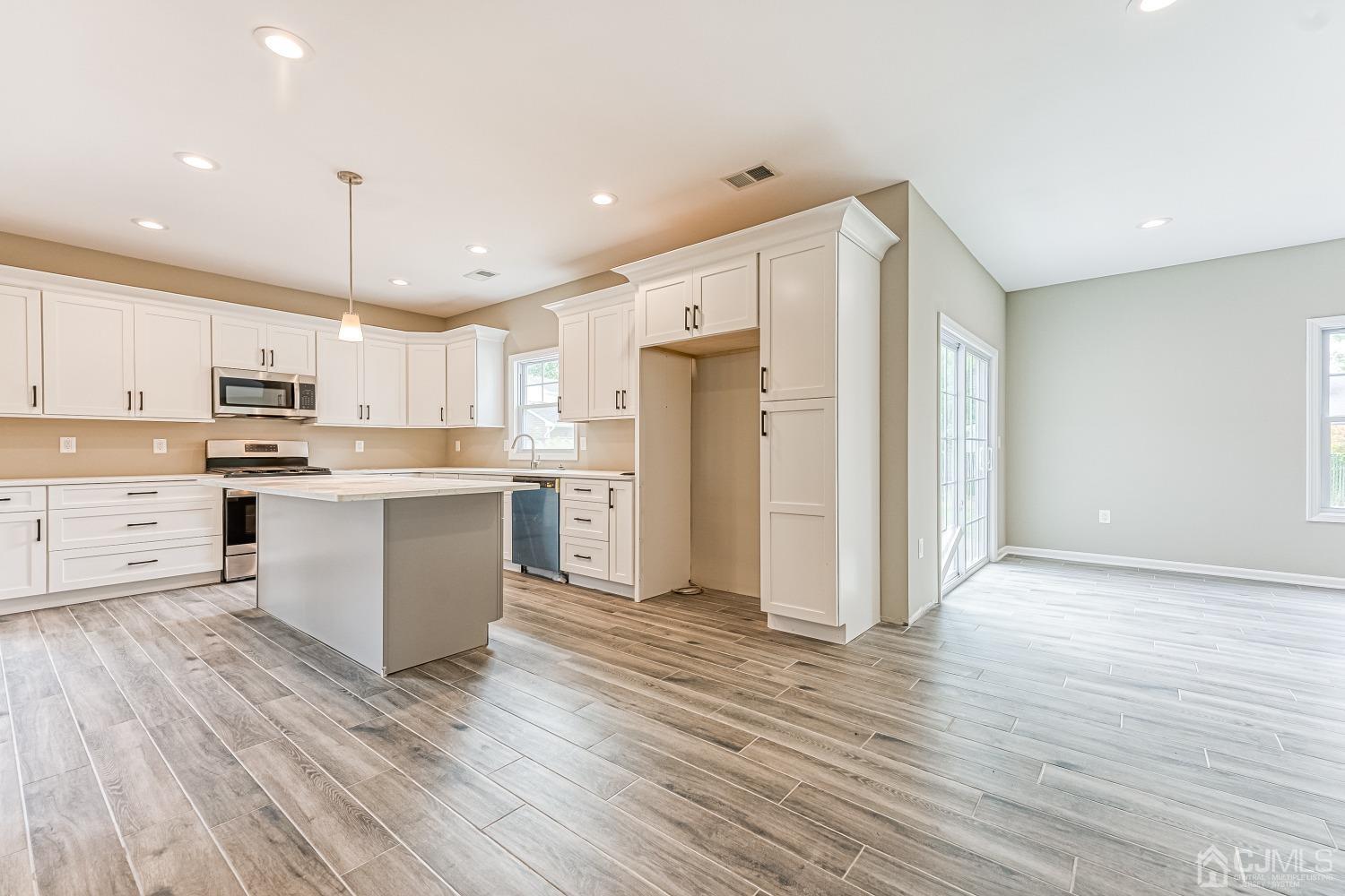19 Crescent Road Edison, NJ 08817 - Photo 11 of 40 a kitchen with stainless steel appliances a refrigerator sink and cabinets