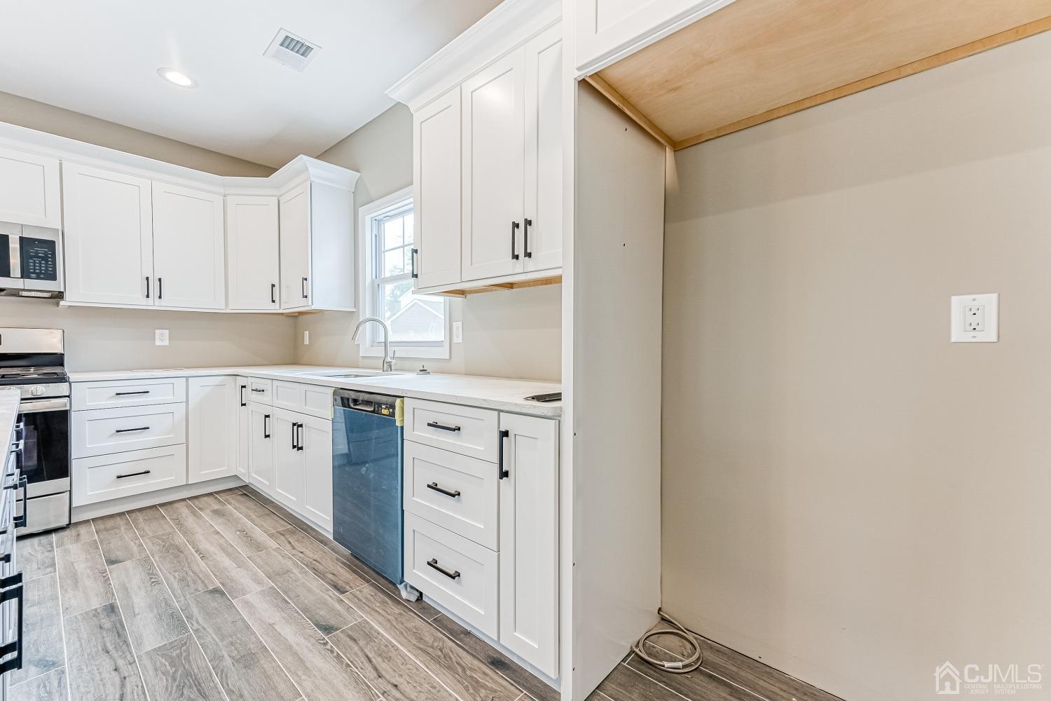 19 Crescent Road Edison, NJ 08817 - Photo 16 of 40 a kitchen with white cabinets and white appliances