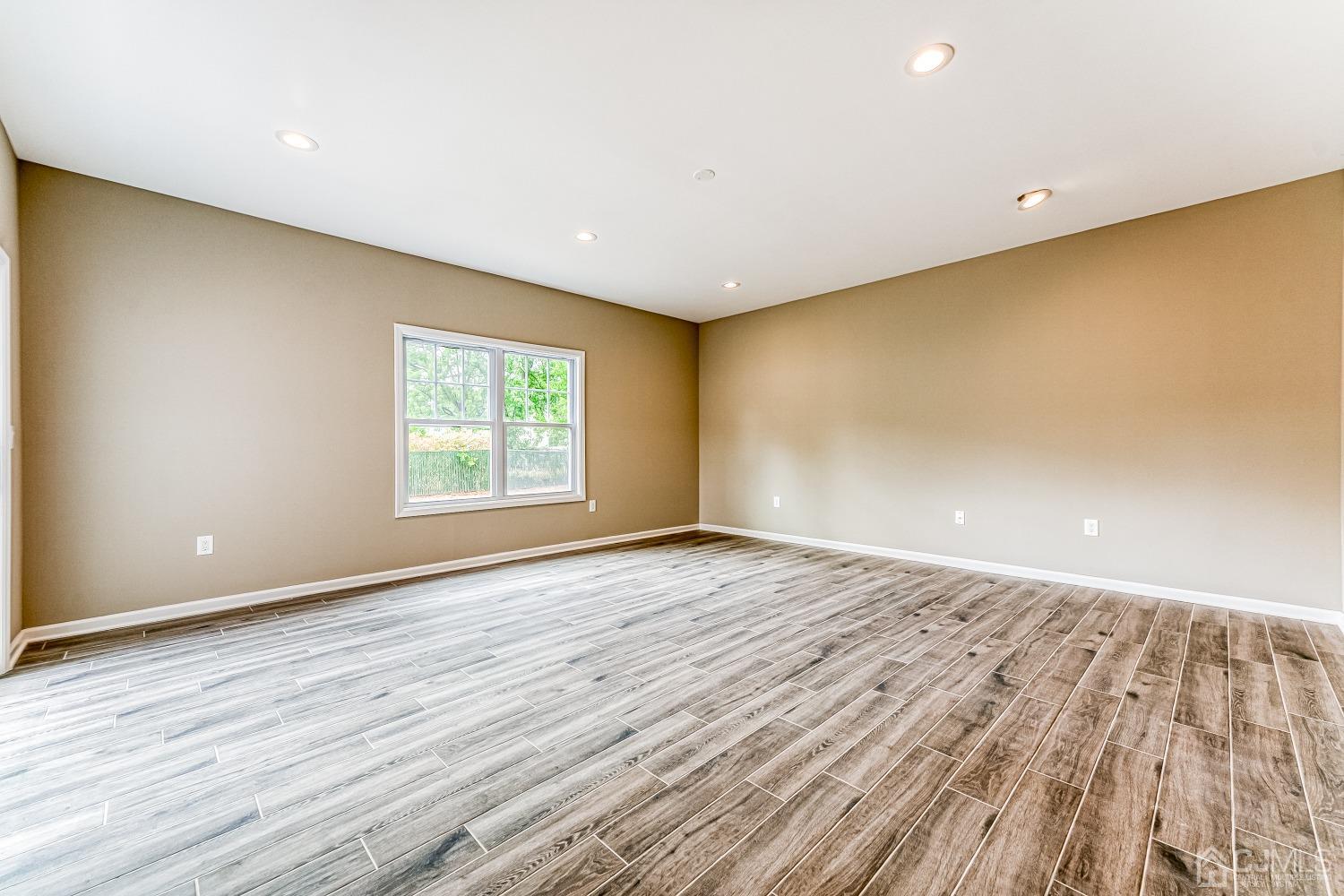 19 Crescent Road Edison, NJ 08817 - Photo 17 of 40 a view of an empty room with wooden floor and a window
