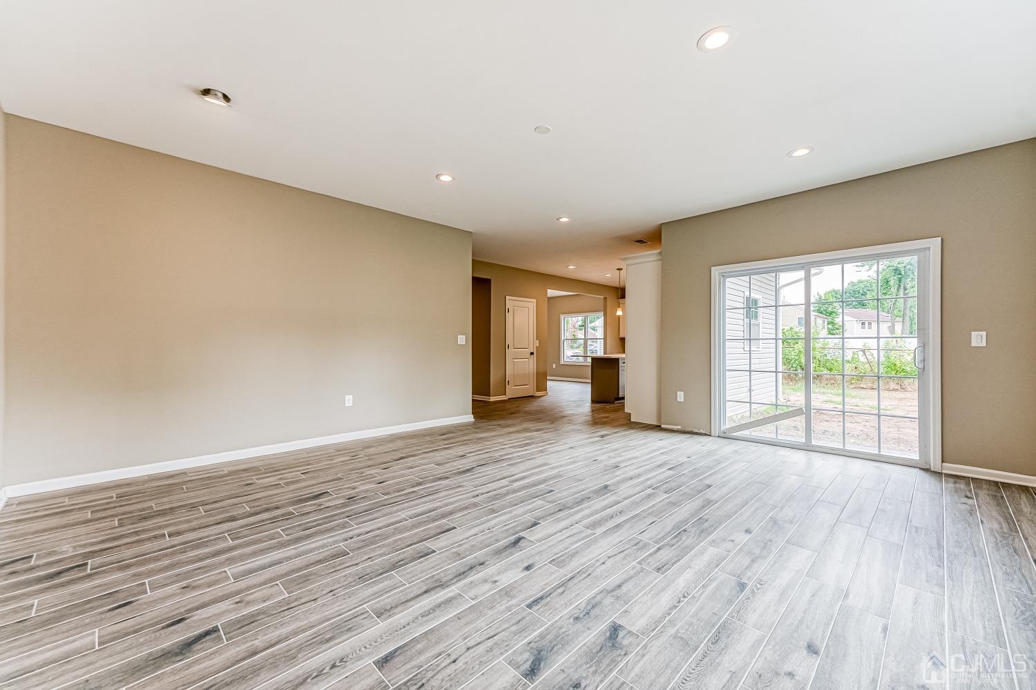 19 Crescent Road Edison, NJ 08817 - Photo 19 of 40 a view of an empty room with wooden floor and a window