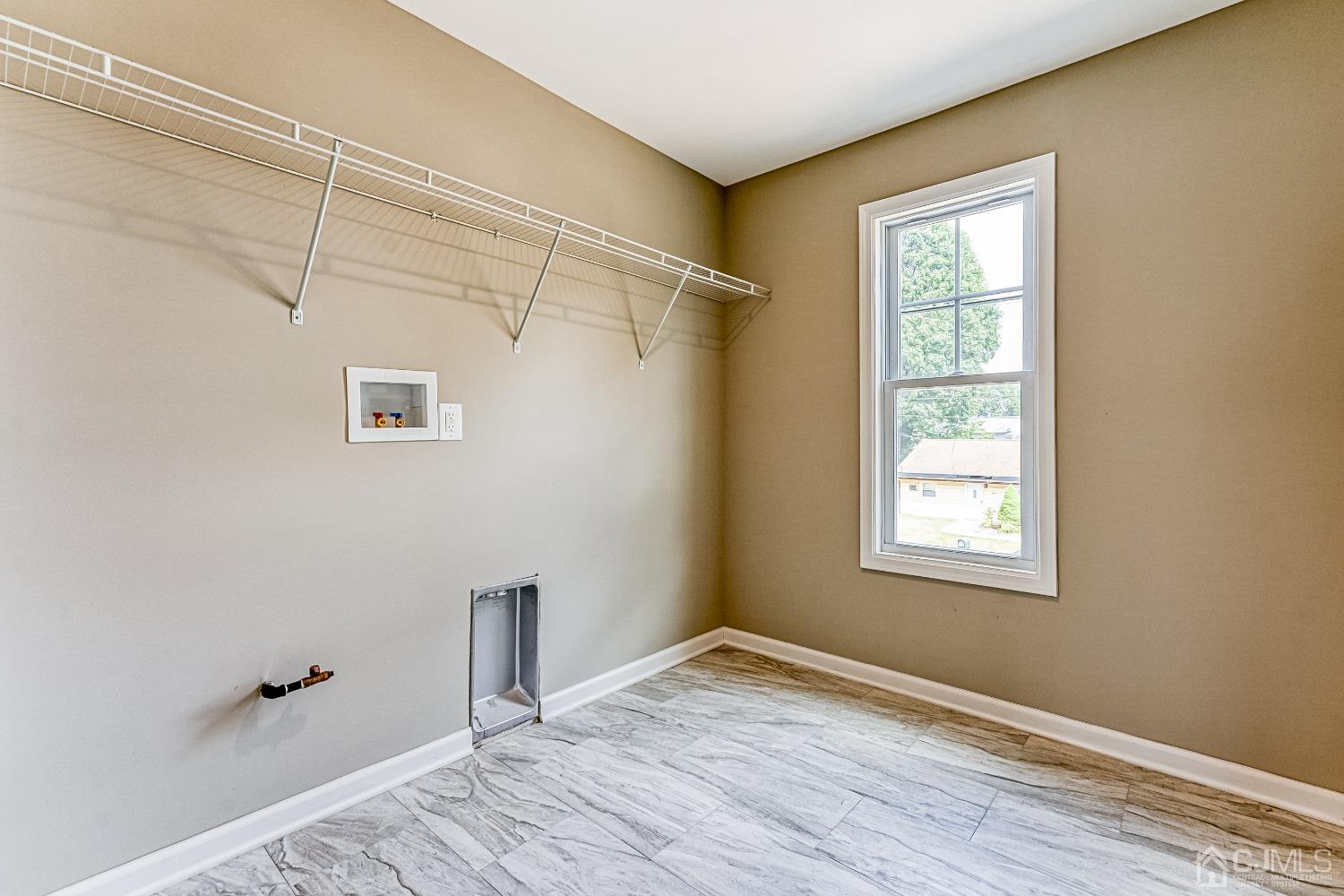 19 Crescent Road Edison, NJ 08817 - Photo 23 of 40 a view of an empty room with wooden floor and a window