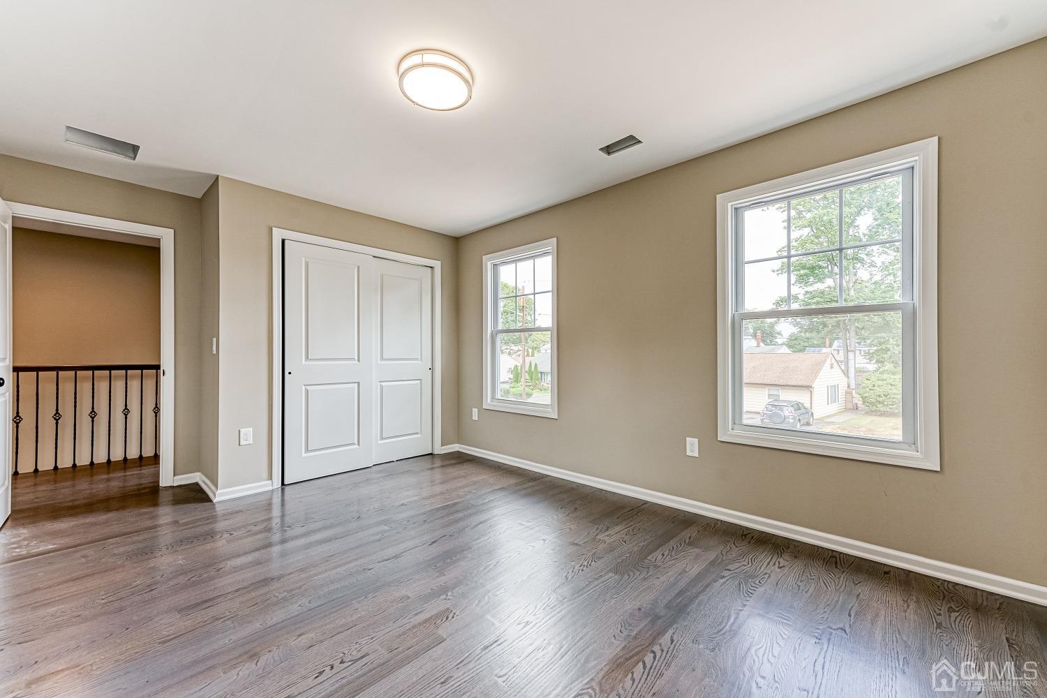 19 Crescent Road Edison, NJ 08817 - Photo 26 of 40 an empty room with wooden floor and windows