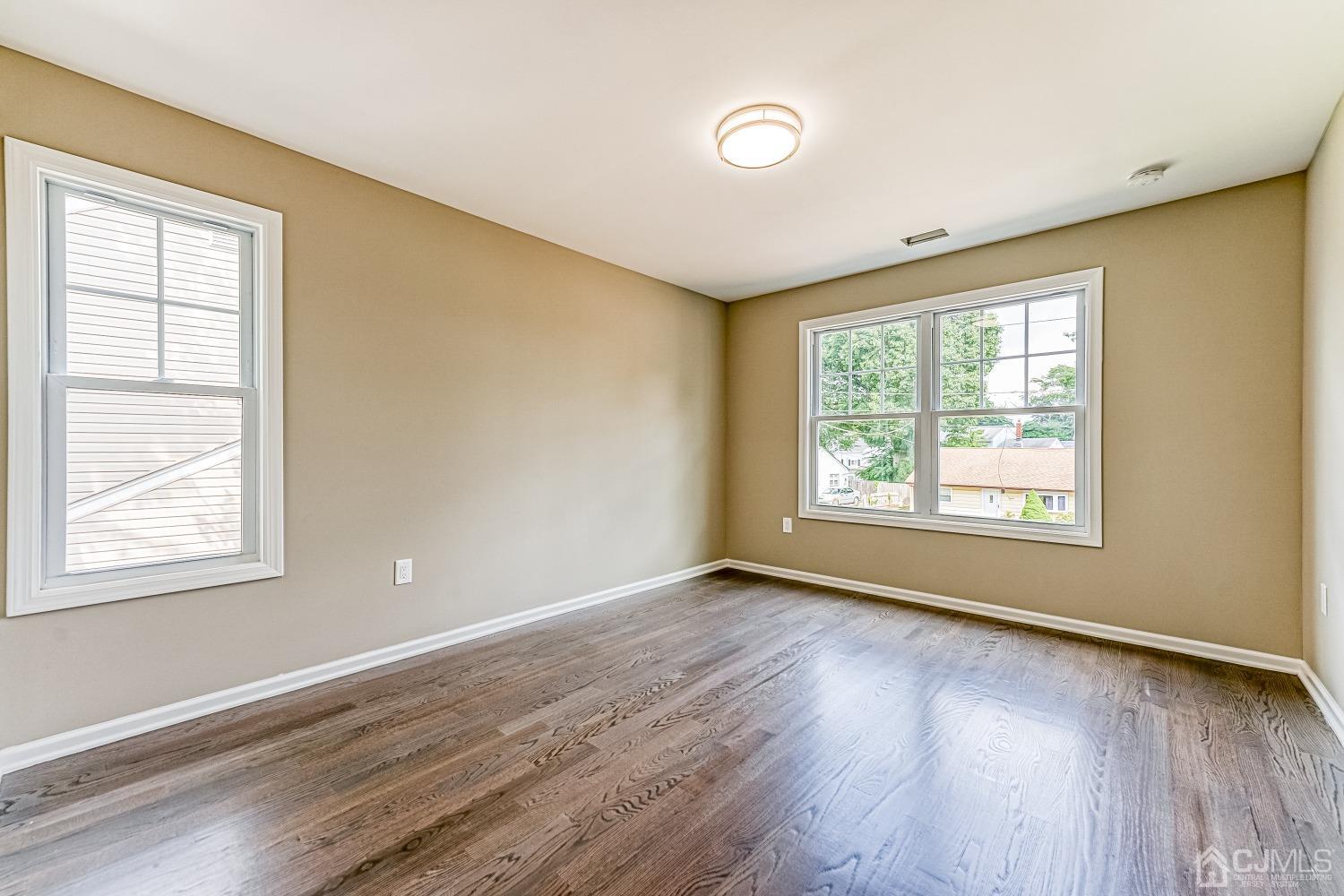 19 Crescent Road Edison, NJ 08817 - Photo 30 of 40 a view of an empty room with wooden floor and a window