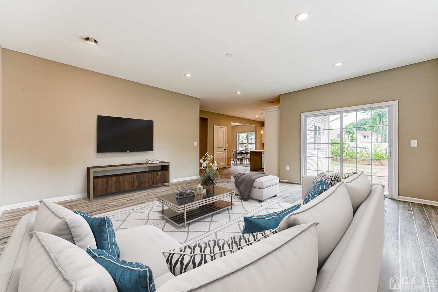 19 Crescent Road Edison, NJ 08817 - Photo 4 of 40 a living room with furniture a flat screen tv and a large window