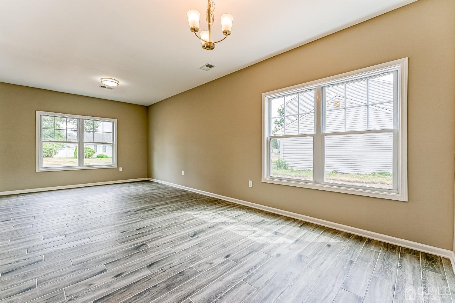19 Crescent Road Edison, NJ 08817 - Photo 8 of 40 a view of an empty room with wooden floor and a window