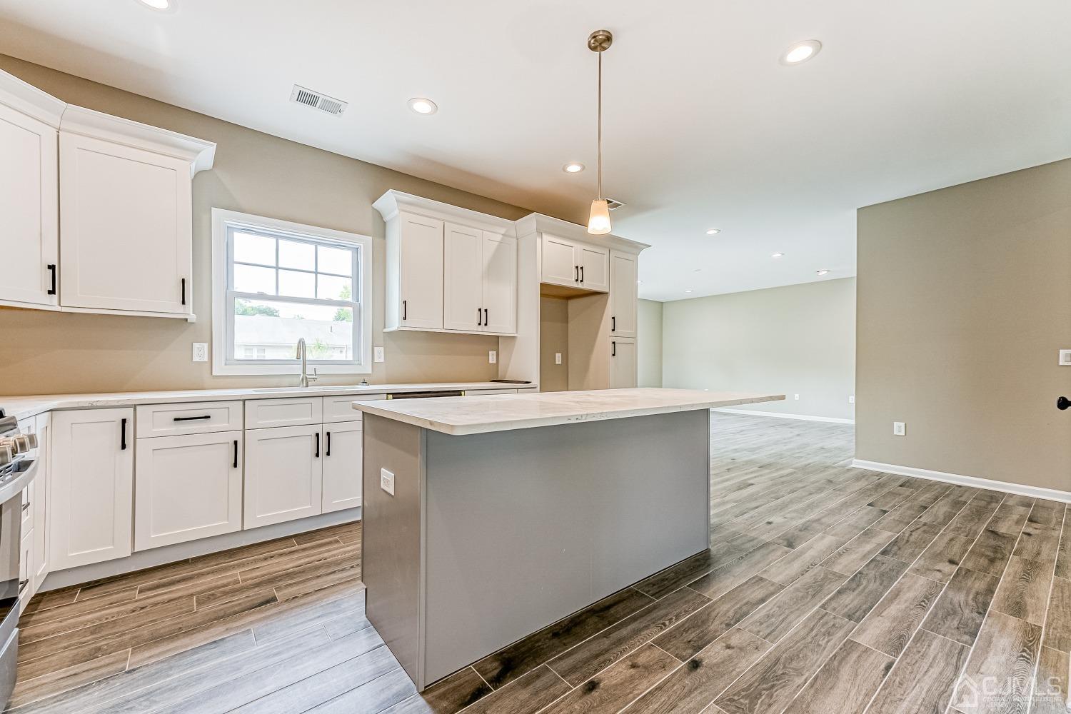 19 Crescent Road Edison, NJ 08817 - Photo 9 of 40 a kitchen with stainless steel appliances granite countertop a sink a window and white cabinets