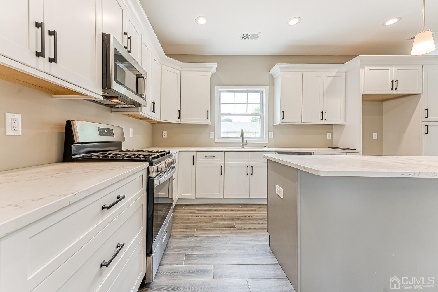 19 Crescent Road Edison, NJ 08817 - Photo 10 of 40 a kitchen with granite countertop white cabinets and white appliances