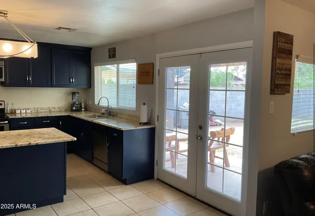 a kitchen with a sink window and cabinets