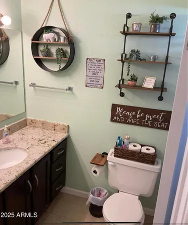 a bathroom with a toilet a sink and mirror