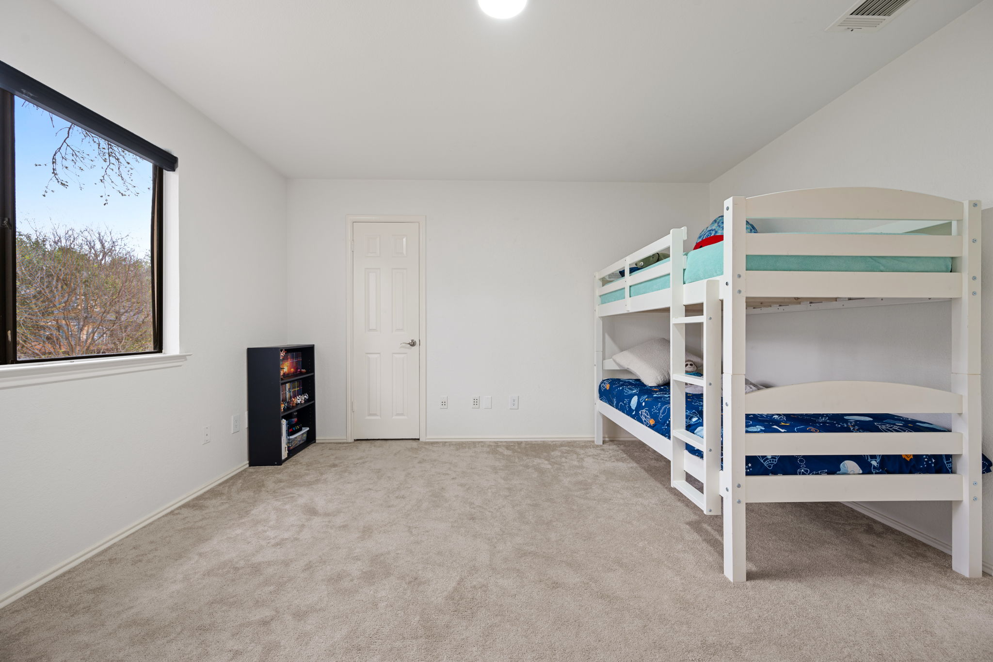 11942 Bittern Hollow Austin, TX 78758 - Photo 19 of 29 a bedroom with furniture and window